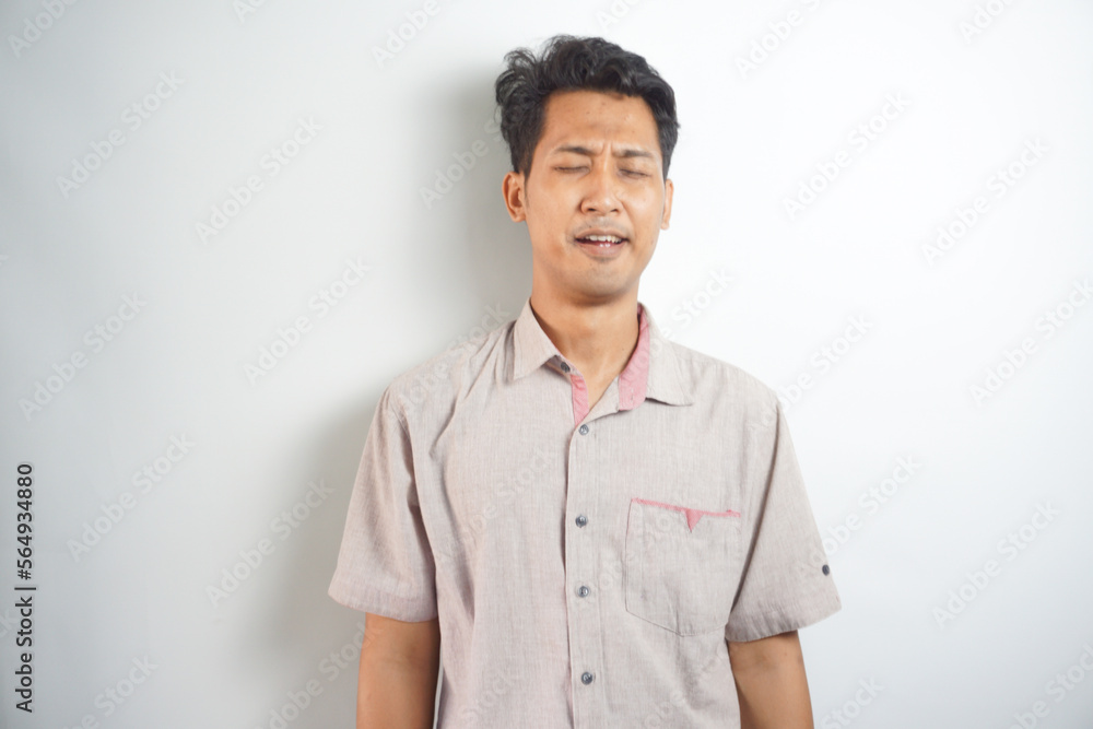 Funny asian man crying wipes tears losing his job.