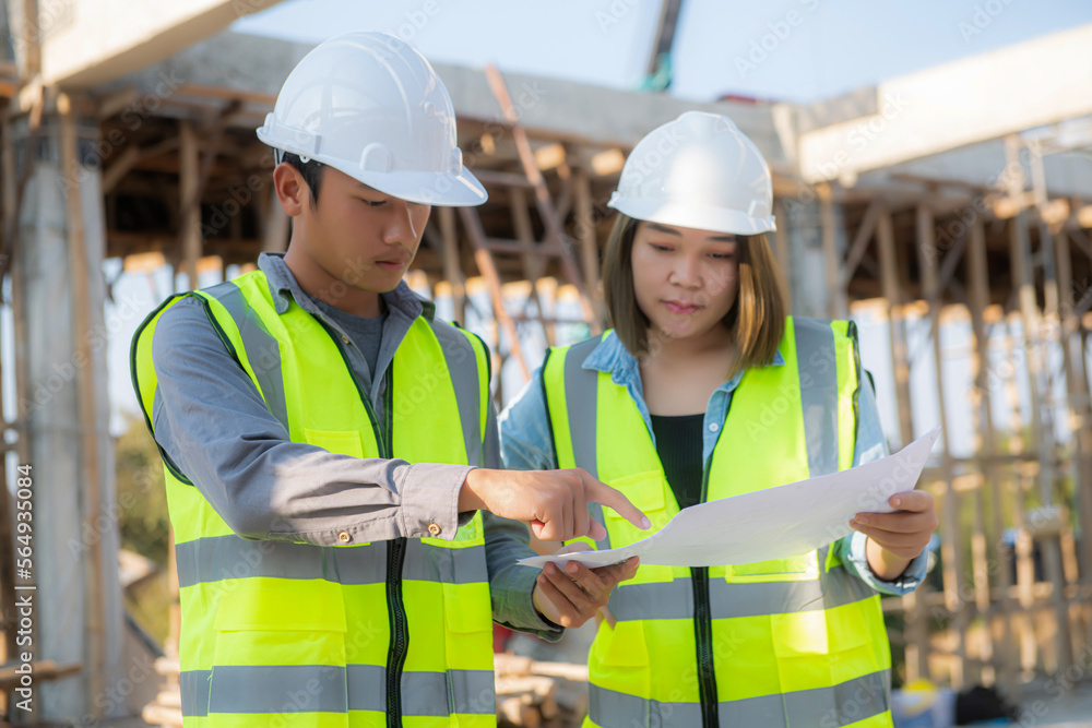 Structural engineer and foreman worker with blueprints discuss, plan inspecting for the outdoors building construction site. Structural engineer and foreman worker with blueprints discuss, plan inspecting for the outdoors building construction site.