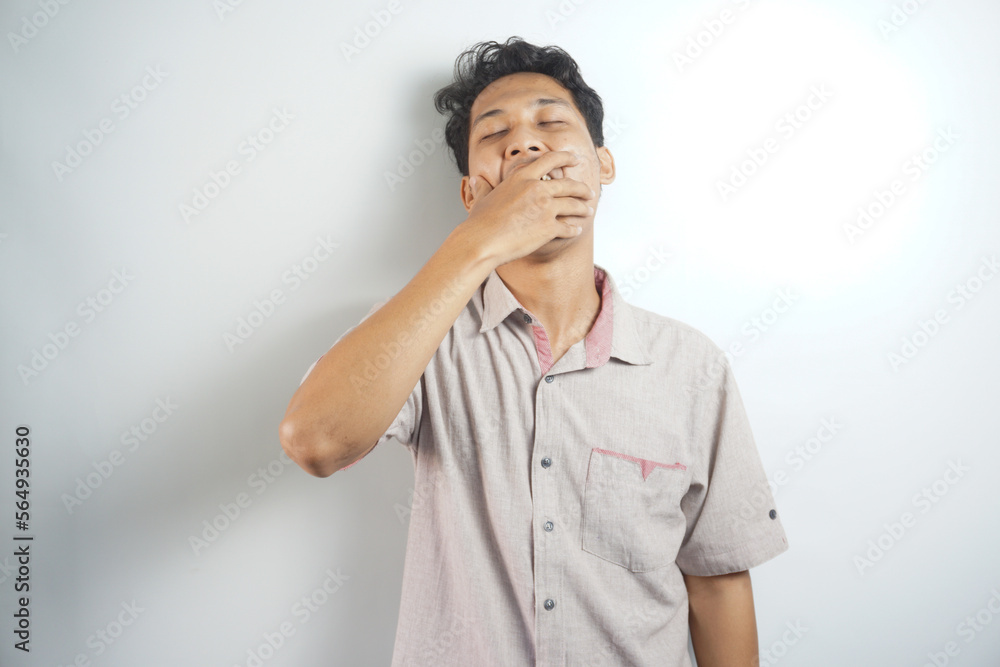 A tired man wearing a shirt is yawning A tired man wearing a shirt is yawning