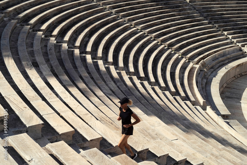 A woman runs in an ancient stadium. photo