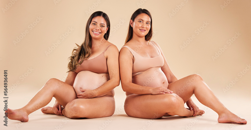 Women, portrait or sitting with pregnant stomach, tummy growth progress or baby healthcare wellness on studio background. Smile, happy or friends in pregnancy underwear for solidarity support or love Women, portrait or sitting with pregnant stomach, tummy growth progress or baby healthcare wellness on studio background. Smile, happy or friends in pregnancy underwear for solidarity support or love