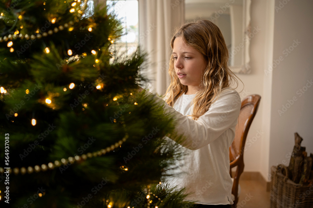 Girl decorating Christmas tree Girl decorating Christmas tree