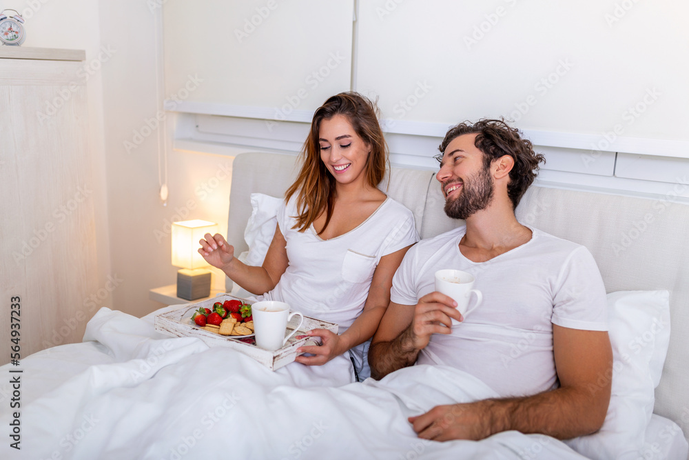 Romantic breakfast in bed on Valentines day man prepare for his woman, she was very happy, Young beautiful couple in bed having a breakfast and coffee in bed