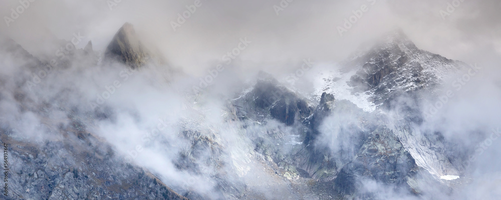 Fantastic snow mountains landscape banner background with snow peaks and clouds, French Alps, Europe