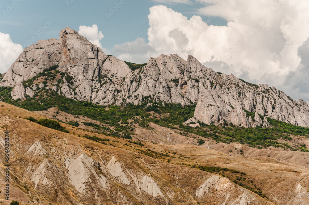 A view of the mountains and sunny day with blue sky and clouds in Crimea.