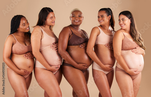 Happy women, body or holding pregnant stomach in support line, solidarity or community diversity on studio background. Pregnancy, friends and people in underwear for belly growth or mothers day pride