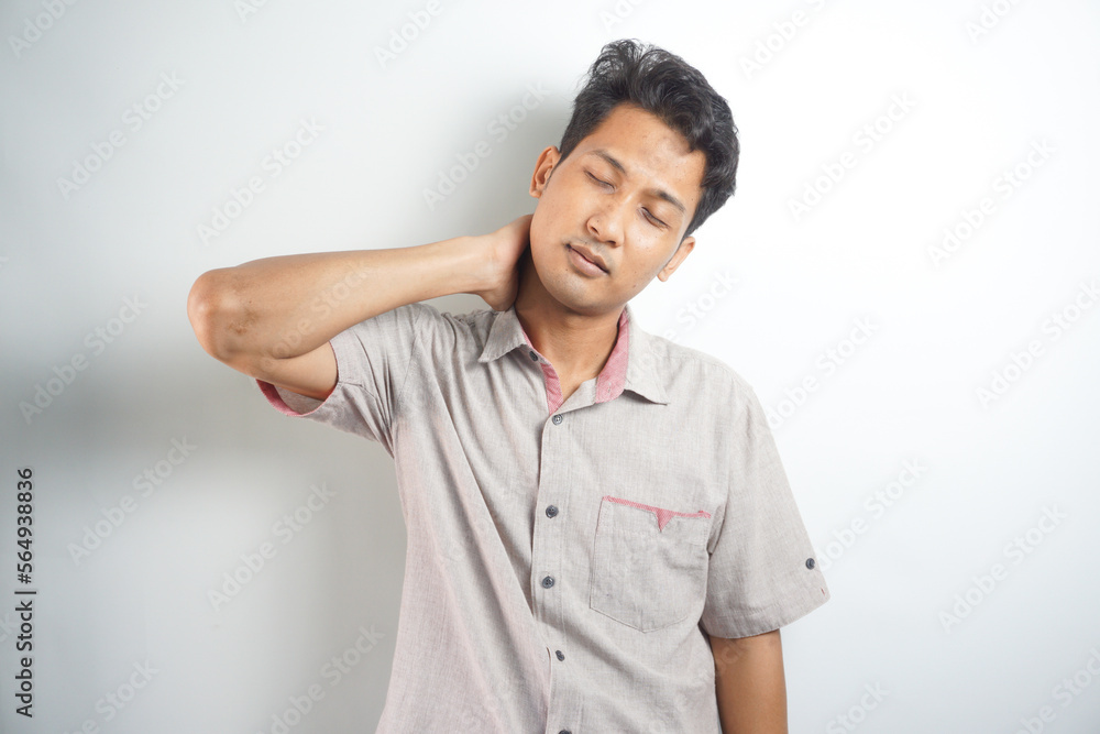 stressed, unhappy young handsome asian man with bad neck pain stressed, unhappy young handsome asian man with bad neck pain
