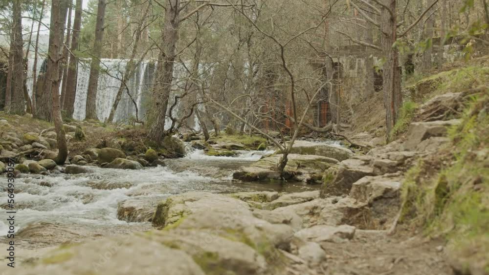 steady shot of a river and waterfall with trees steady shot of a river and waterfall with trees