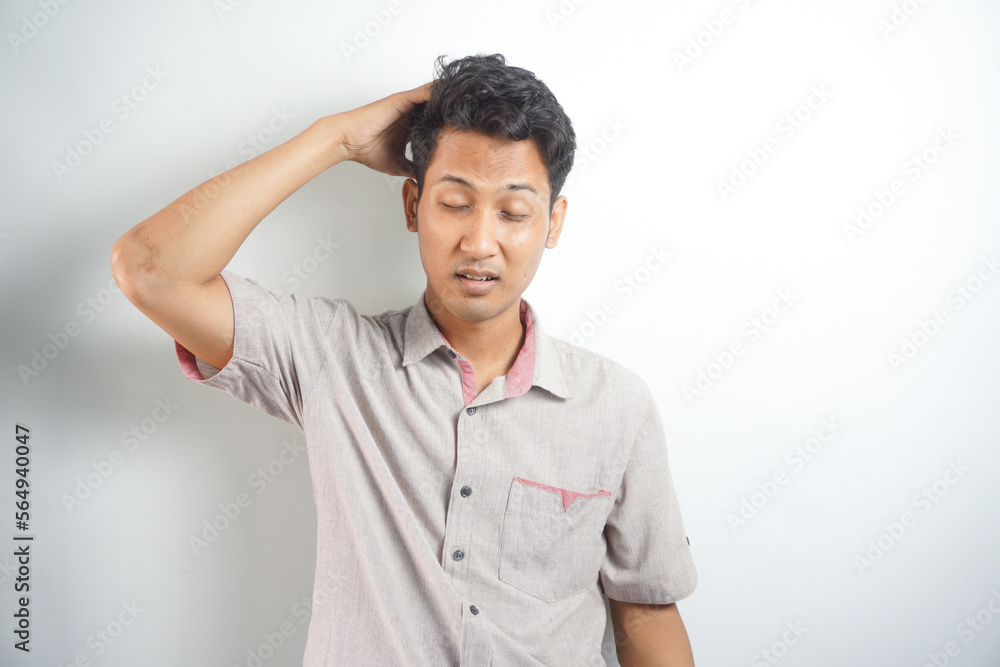 Horizontal photo of good-looking asian man pictured isolated on white background showing how much his head hurts, experiencing pain, looking miserable and exhausted Horizontal photo of good-looking asian man pictured isolated on white background showing how much his head hurts, experiencing pain, looking miserable and exhausted