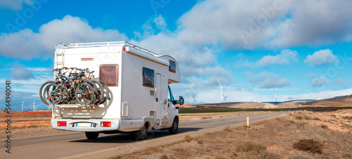Motorhome on the road and windmill in the background