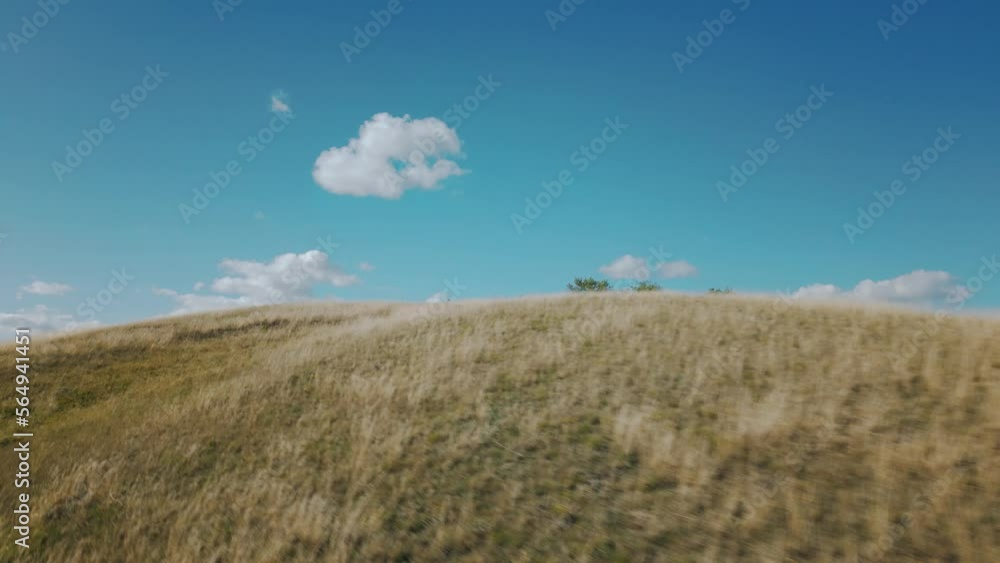 Aerial of golden hillside on warm sunny day Aerial of golden hillside on warm sunny day