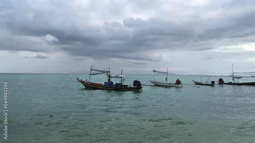 Fishing boats in the sea at the pier in cloudy cloudy weather. The Gulf of Thailand is part of the South China Sea, washing the southwestern coast of Thailand. High quality 4k footage Fishing boats in the sea at the pier in cloudy cloudy weather. The Gulf of Thailand is part of the South China Sea, washing the southwestern coast of Thailand. High quality 4k footage