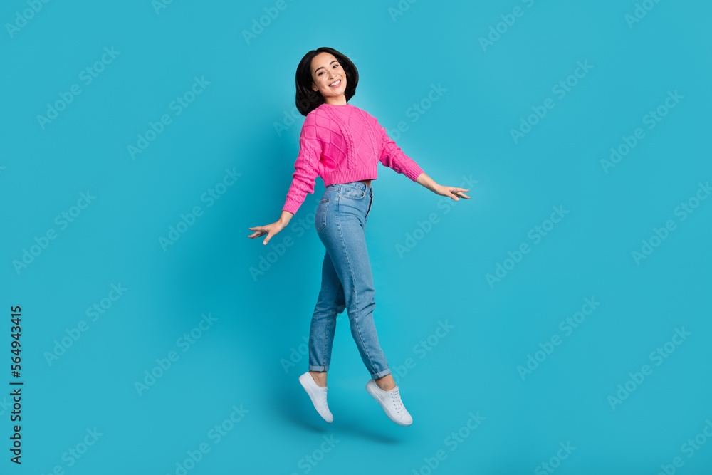 Full length photo of sweet shiny lady wear pink pullover walking jumping high isolated blue color background