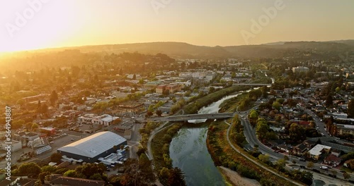 Santa Cruz California Aerial v13 flyover above san lorenzo river with sunset shinning across town, pan right on soquel avenue bridge capturing charming neighborhood - Shot with Mavic 3 Cine - May 2022 photo