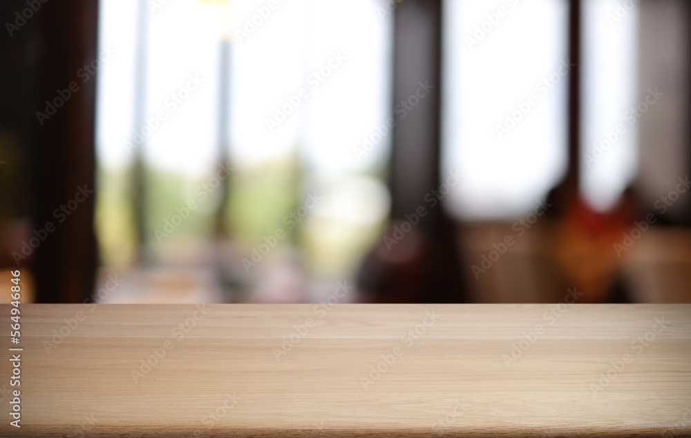 Empty wooden table in front of abstract blurred background of coffee shop . can be used for display or montage your products.Mock up for display of product Empty wooden table in front of abstract blurred background of coffee shop . can be used for display or montage your products.Mock up for display of product