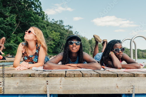 Three friends laying on a dock