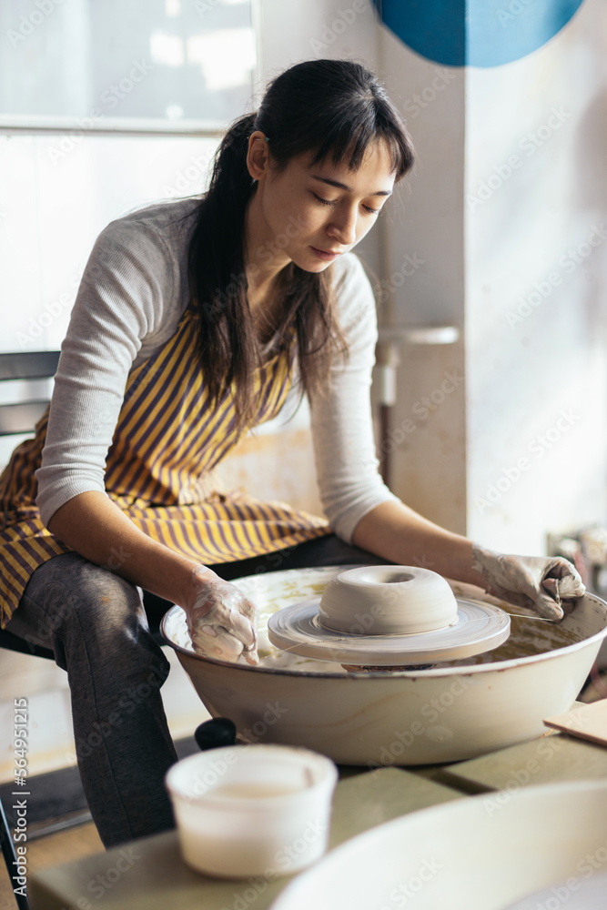 Young Woman Working In A Pottery Workshop Young Woman Working In A Pottery Workshop