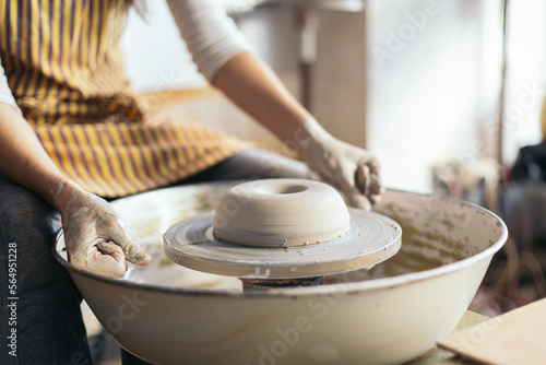 Female artisan shaping clay in a pottery workshop