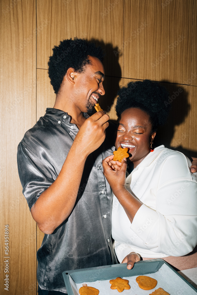 Man and Woman Eating Christmas Cookies Man and Woman Eating Christmas Cookies