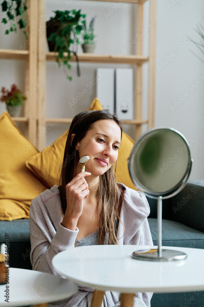 Woman Using Jade Roller For Skincare Treatment.