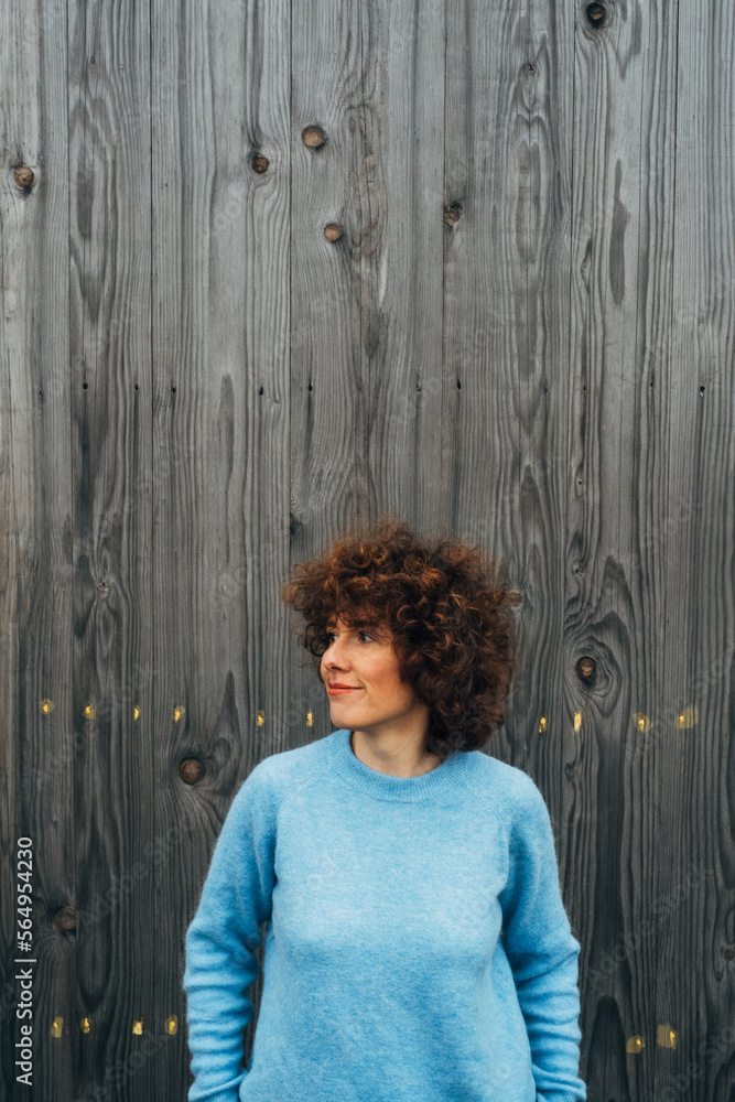 Portrait of Beautiful Smiling Red Haired Woman on Wooden Background Portrait of Beautiful Smiling Red Haired Woman on Wooden Background