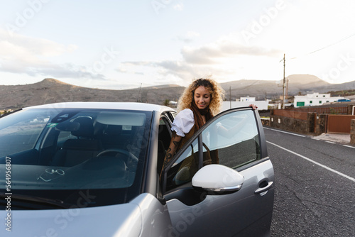 Woman getting into car photo