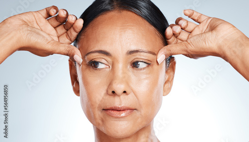 Billede på lærred Skincare, beauty and senior woman thinking of wrinkles isolated on a grey studio background