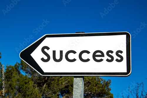 the word 'success' written on a road sign
