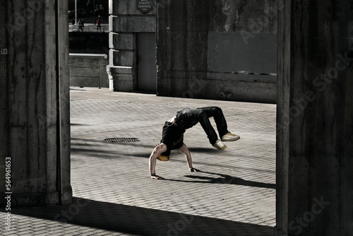 Young adult breakdancing under a bridge in Bilbao, Spain. photo