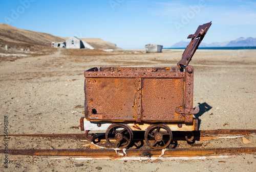 Remains of narrow gauge railway and carriage at the abandoned coal mining operation in Calypsobyen, Svalbard. photo