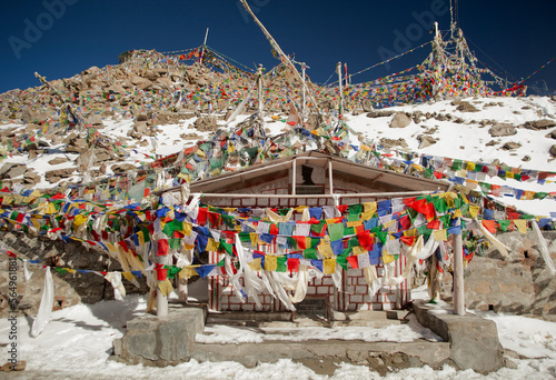 Prayer flags on the road from Leh, the capital of Ladakh to The Nubra Valley over The Khardung La pass, one of the highest motorable roads in the world photo