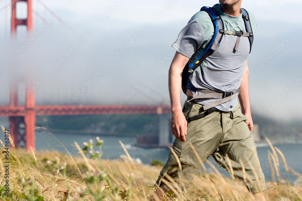Young man hiking the Marin Headlands, Golden Gate National Recreation Area, San Francisco, California. Young man hiking the Marin Headlands, Golden Gate National Recreation Area, San Francisco, California.