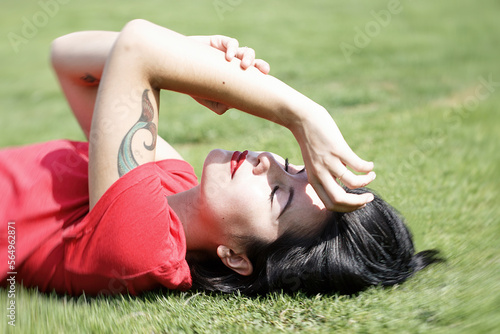 beautiful woman lying on the grass V photo