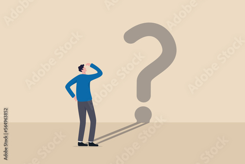 Confusion, uncertainty or self doubt, finding meaning in live, question to answer or searching solution to solve problem concept, curios businessman looking at self shadow as question mark sign.