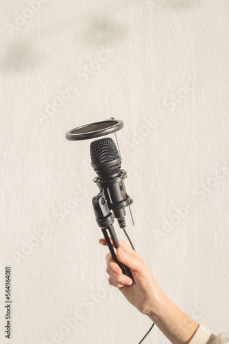 Podcast Equipment - Female Hand Holding Microphone.