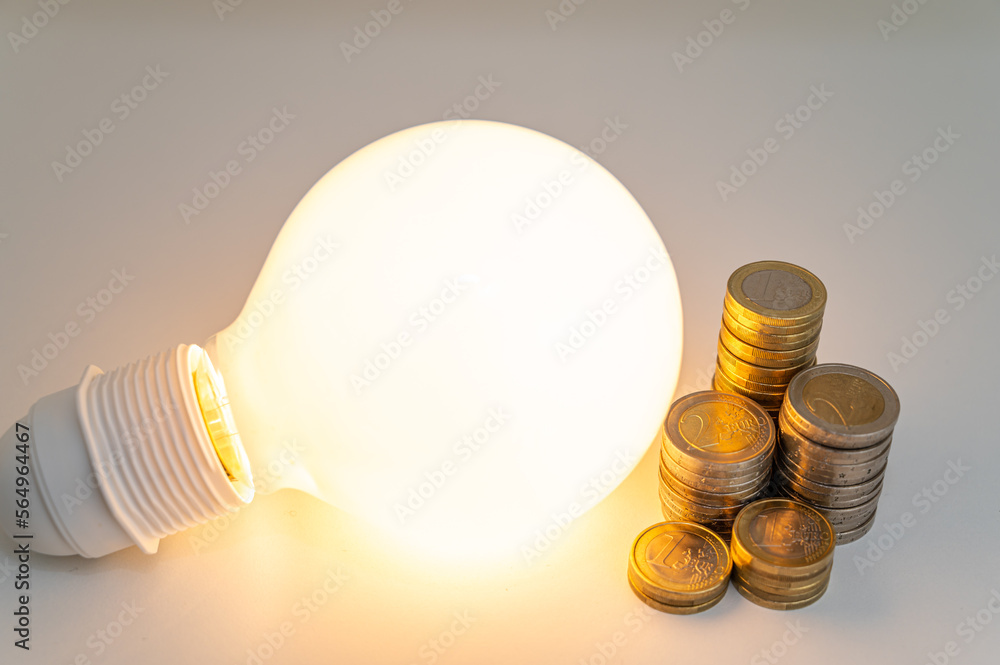 Light bulb turned off, with stacks of coins next to it. Rising electricity tariffs, energy dependency, energy sources and energy supplies.
Light bulb turned off, with stacks of coins next to it. Rising electricity tariffs, energy dependency, energy sources and energy supplies.