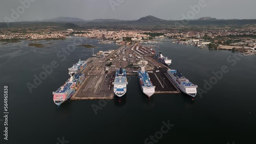 Tirrenia e Moby Lines, Olbia - Italy - Sardinia - 10 June 2022. Aerial view of the touristic and industrial port with line ferries in the harbour and urban panorama city photo