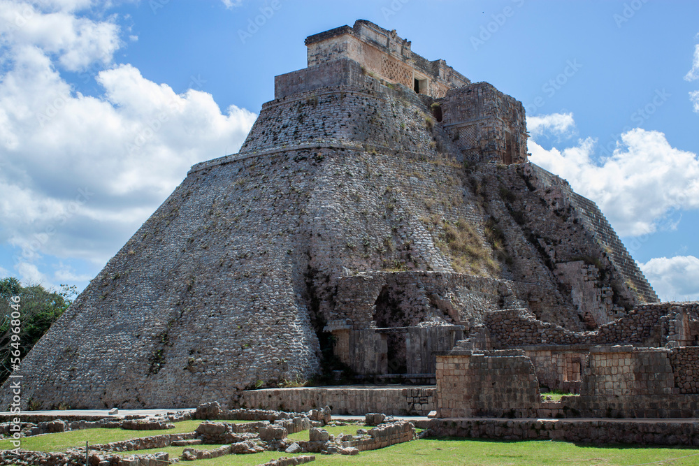 Ancient ruins, walls, and Pyramid of the Magician, a historical Archeological site in Uxmal, near Mérida. Mayan city ruins, representative of the Puuc architectural style, in Yucatán Peninsula, Mexico
