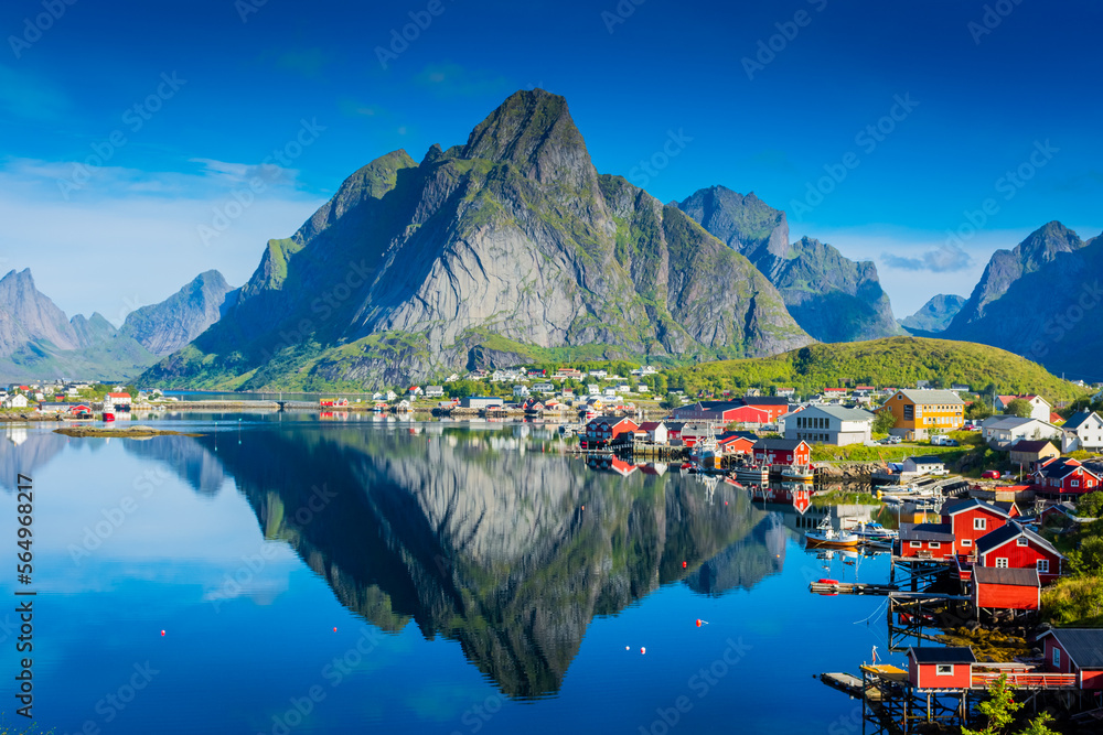 Perfect reflection of the Reine village on the water of the fjord in the Lofoten Islands, Norway