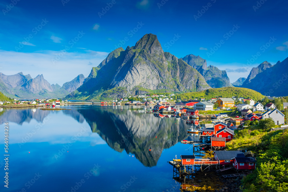 Perfect reflection of the Reine village on the water of the fjord in the Lofoten Islands,  Norway - obrazy, fototapety, plakaty 