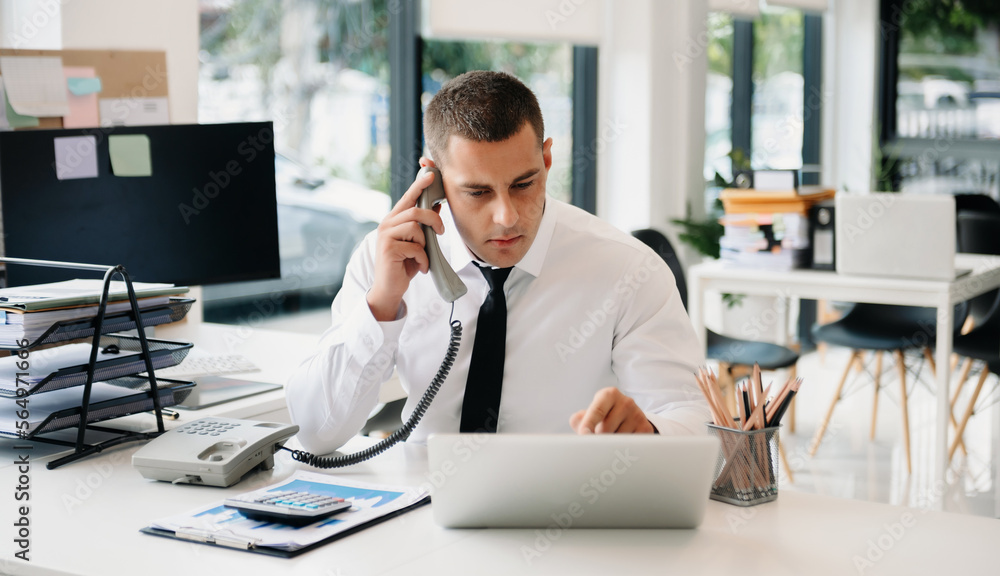 Happy business man have the joy of talking on the smartphone, tablet and laptopon the modern office Happy business man have the joy of talking on the smartphone, tablet and laptopon the modern office