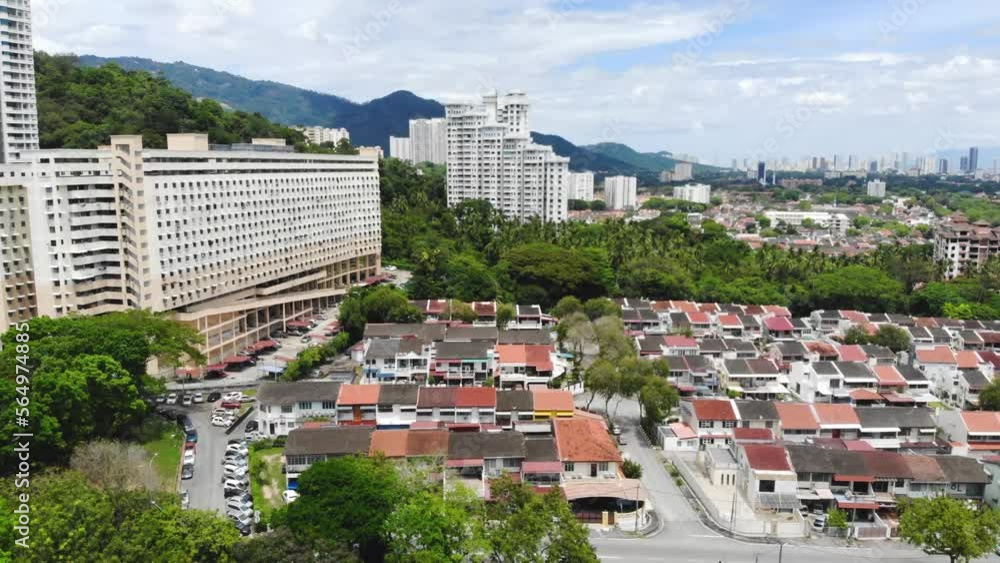Aerial view of modern apartments and houses near tropical greenery Aerial view of modern apartments and houses near tropical greenery