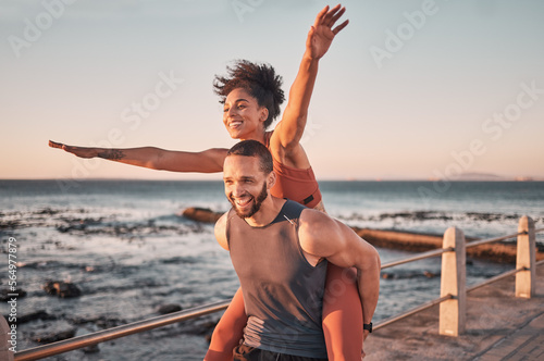 Photography Sunset, relax and couple piggyback by ocean enjoying holiday, vacation and quality time on weekend