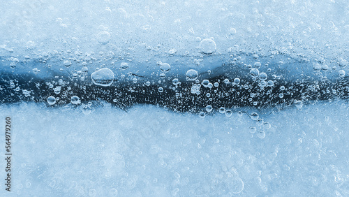 Ice with frozen air bubbles, close-up natural texture