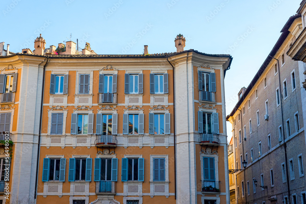 Part of a townhouse on a sunny day in Rome. Windows, facades, building, architecture. 