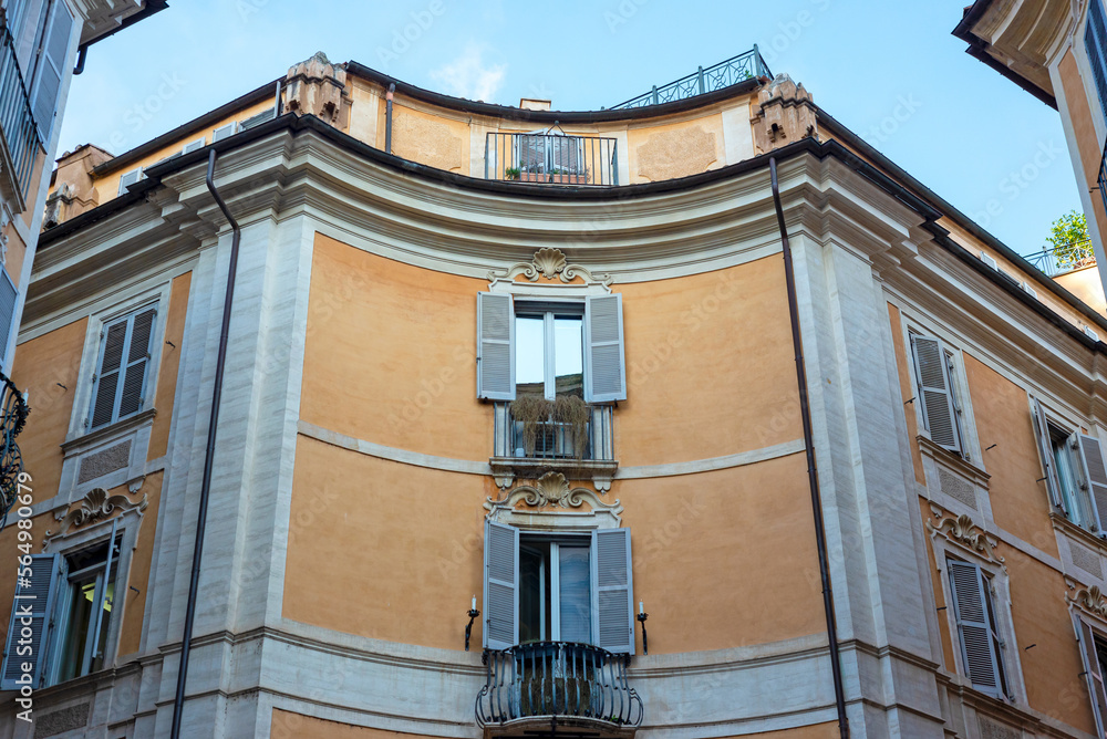 Part of a townhouse on a sunny day in Rome. Windows, facades, building, architecture.