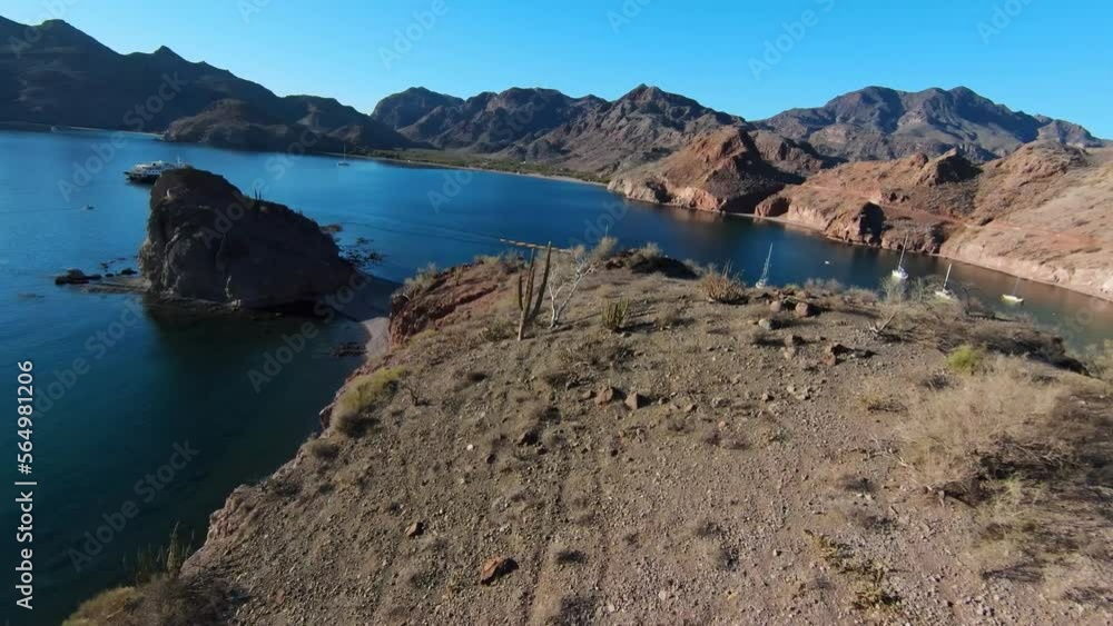 Fpv Drone Shot Over Coastal Arid Dry Hill Overlooking Sea Bay and Pleasure Boats On Water in Baja Region Mexico, Mountains in Horizon Fpv Drone Shot Over Coastal Arid Dry Hill Overlooking Sea Bay and Pleasure Boats On Water in Baja Region Mexico, Mountains in Horizon