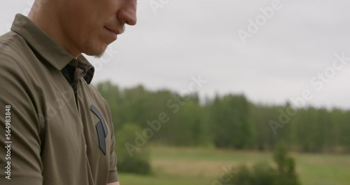 Disc golfer warms up to putt - Hand held close up dolly up shot photo