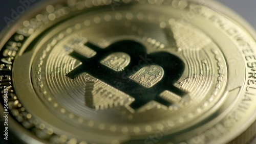 Detailed close-up shot over golden bitcoin cash coin; shadow pass over photo