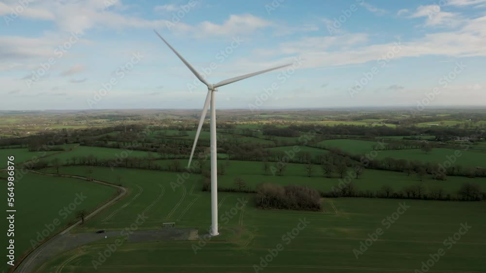 Isolated eolic wind turbine with blades rotating in green countryside. Aerial drone view Isolated eolic wind turbine with blades rotating in green countryside. Aerial drone view